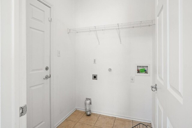 141 Ashwood N, Kyle, TX 78640 - laundry area with hookup for an electric dryer, hookup for a washing machine, and light tile patterned floors