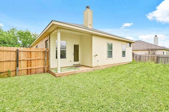 141 Ashwood N, Kyle, TX 78640 - back of house with a chimney and a fenced backyard