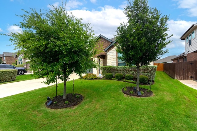 6007 Agostino Cv, Round Rock, TX 78665 - obstructed view of property featuring concrete driveway and stone siding