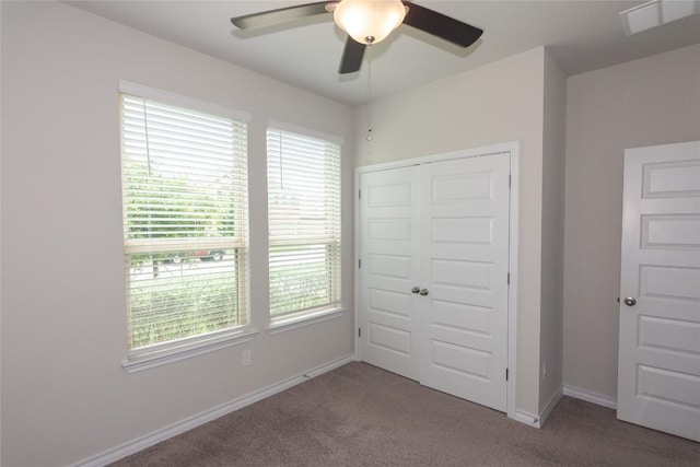 6007 Agostino Cv, Round Rock, TX 78665 - unfurnished bedroom with carpet flooring, multiple windows, a closet, and ceiling fan