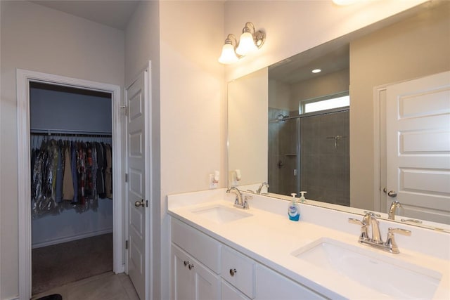 6007 Agostino Cv, Round Rock, TX 78665 - full bathroom featuring a shower stall, double vanity, a walk in closet, and tile patterned floors