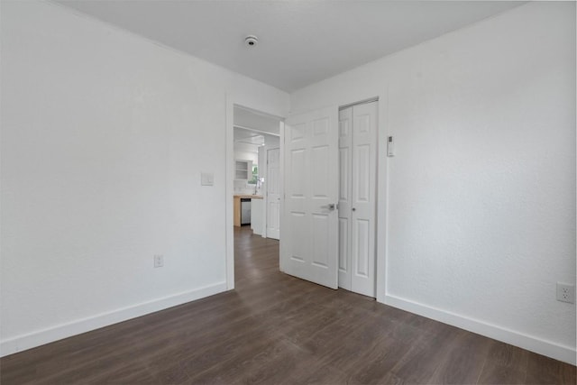 1216 Jones St, Taylor, TX 76574 - unfurnished room featuring baseboards and dark wood-type flooring