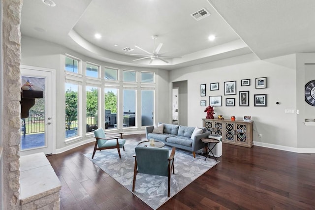 1720 Boscello Ct, Leander, TX 78641 - living room with a tray ceiling, dark wood-type flooring, ceiling fan, and recessed lighting