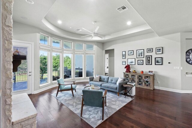 1720 Boscello Ct, Leander, TX 78641 - living room featuring a raised ceiling, dark wood-style floors, a ceiling fan, and recessed lighting