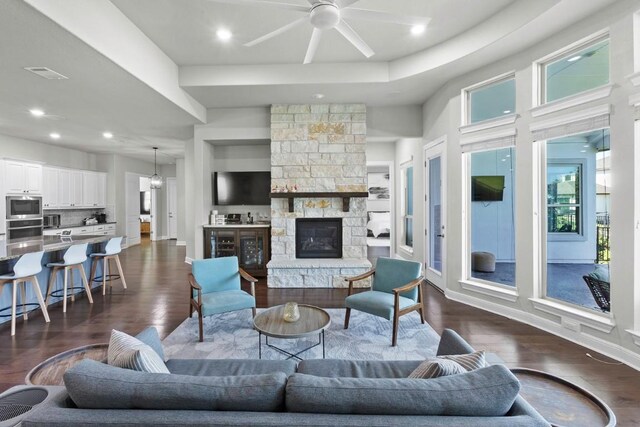 1720 Boscello Ct, Leander, TX 78641 - living room with a ceiling fan, dark wood-style flooring, recessed lighting, and a stone fireplace