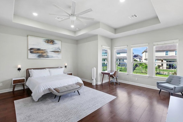 1720 Boscello Ct, Leander, TX 78641 - bedroom with a tray ceiling, dark wood-type flooring, recessed lighting, and ceiling fan