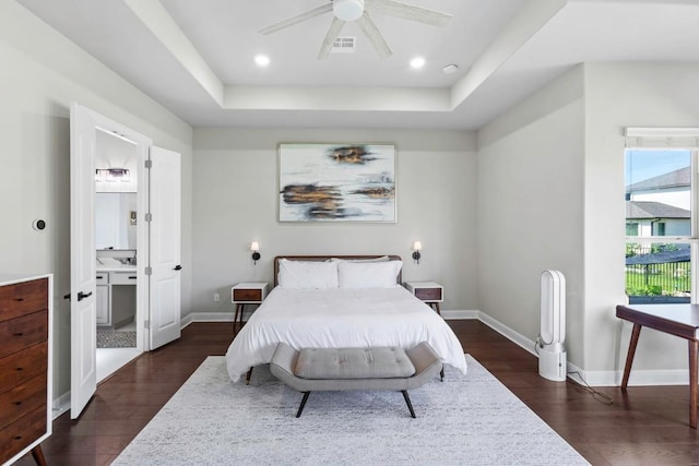 1720 Boscello Ct, Leander, TX 78641 - bedroom featuring dark wood-type flooring, a raised ceiling, ceiling fan, and connected bathroom