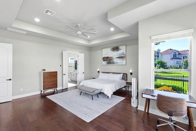 1720 Boscello Ct, Leander, TX 78641 - bedroom featuring a raised ceiling, dark wood finished floors, recessed lighting, connected bathroom, and a ceiling fan