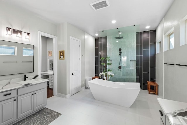 1720 Boscello Ct, Leander, TX 78641 - full bathroom with vanity, a freestanding tub, walk in shower, tile patterned flooring, and recessed lighting