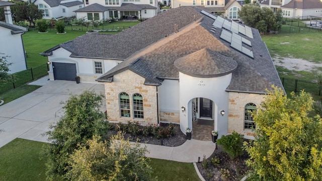 1720 Boscello Ct, Leander, TX 78641 - french provincial home with stone siding, a shingled roof, solar panels, driveway, and a garage