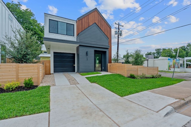 54 Robert T Martinez Jr St, Austin, TX 78702 - modern home with concrete driveway, board and batten siding, and an attached garage