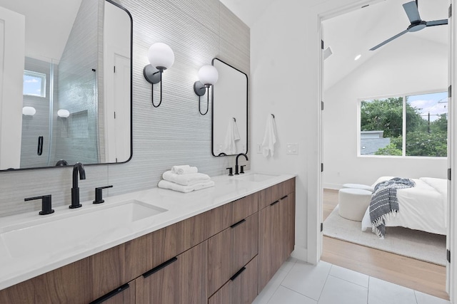 54 Robert T Martinez Jr St, Austin, TX 78702 - full bath with tile patterned floors, vaulted ceiling, healthy amount of natural light, double vanity, and a stall shower