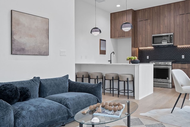 54 Robert T Martinez Jr St, Austin, TX 78702 - living room with light wood finished floors and recessed lighting