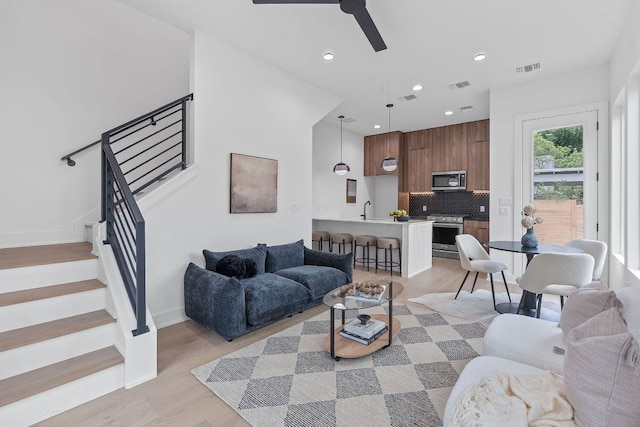 54 Robert T Martinez Jr St, Austin, TX 78702 - living room with ceiling fan, stairs, light wood-type flooring, and recessed lighting