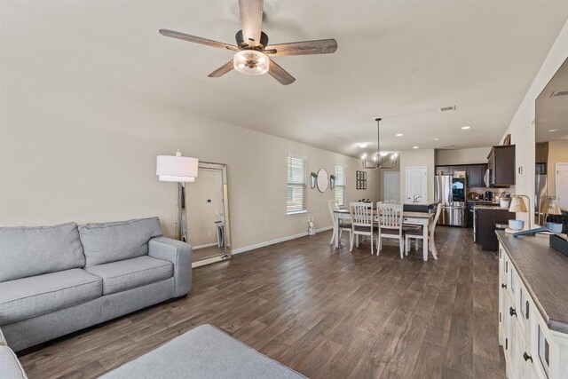 3402 Tilmon Ln, Austin, TX 78725 - living area featuring dark wood finished floors, ceiling fan, a chandelier, and recessed lighting