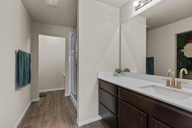 3402 Tilmon Ln, Austin, TX 78725 - bathroom featuring wood finished floors, vanity, and a stall shower