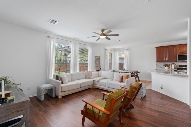 4201 Veiled Falls Dr, Pflugerville, TX 78660 - living room with a ceiling fan and dark wood-style flooring