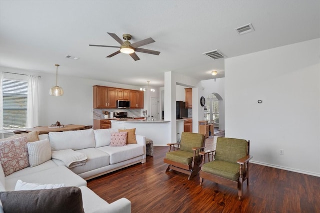 4201 Veiled Falls Dr, Pflugerville, TX 78660 - living room with a ceiling fan, wood finished floors, arched walkways, and plenty of natural light