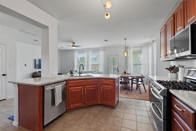 4201 Veiled Falls Dr, Pflugerville, TX 78660 - kitchen featuring stainless steel appliances, a ceiling fan, light tile patterned flooring, and open floor plan