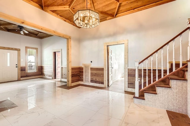 3701 Fm 972, Georgetown, TX 78626 - foyer entrance featuring a wooden ceiling with exposed beams, wainscoting, stairway, marble tiled floors, and a chandelier