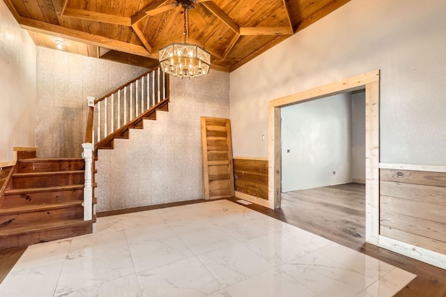 3701 Fm 972, Georgetown, TX 78626 - staircase featuring a wood ceiling with exposed beams, a chandelier, marble look tiles, and a towering ceiling