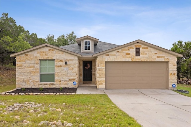 1703 Omaha Dr, Lago Vista, TX 78645 - view of front of house featuring stone siding, driveway, a garage, a front yard, and roof with shingles