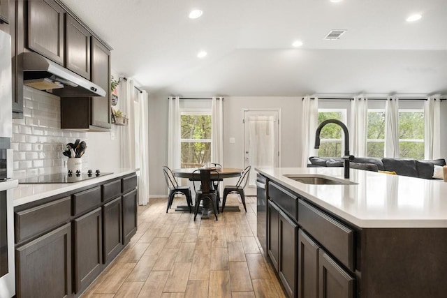 1703 Omaha Dr, Lago Vista, TX 78645 - kitchen featuring under cabinet range hood, black electric cooktop, light countertops, dark brown cabinets, and recessed lighting