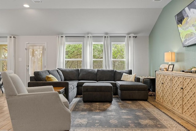 1703 Omaha Dr, Lago Vista, TX 78645 - living room featuring healthy amount of natural light, wood finished floors, recessed lighting, and vaulted ceiling