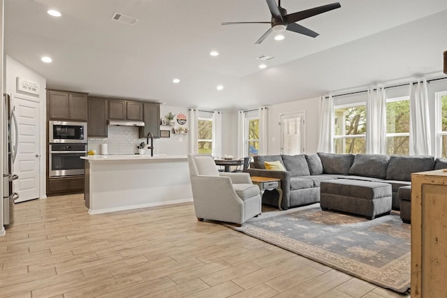 1703 Omaha Dr, Lago Vista, TX 78645 - living area featuring a ceiling fan, light wood finished floors, recessed lighting, and lofted ceiling