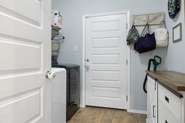 1703 Omaha Dr, Lago Vista, TX 78645 - laundry room featuring separate washer and dryer and light wood-style flooring