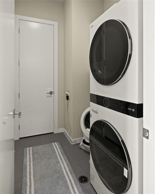 5921 Hiline Rd Unit 2404, Austin, TX 78734 - washroom with stacked washer / dryer and tile patterned flooring