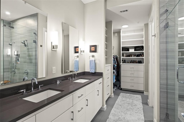 5921 Hiline Rd Unit 2404, Austin, TX 78734 - bathroom featuring a shower stall, a spacious closet, and double vanity