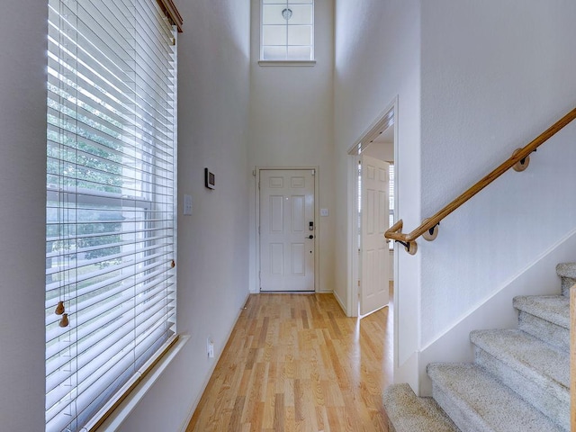 11509 Timber Heights Dr, Austin, TX 78754 - entryway with stairs, light wood-style flooring, healthy amount of natural light, and a towering ceiling