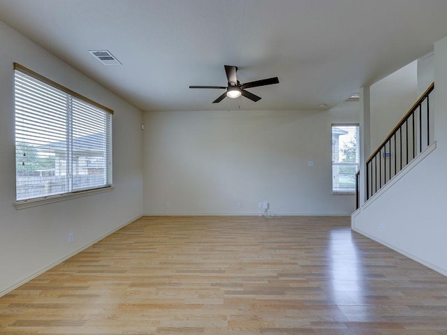 11509 Timber Heights Dr, Austin, TX 78754 - spare room with light wood finished floors, a ceiling fan, and stairway