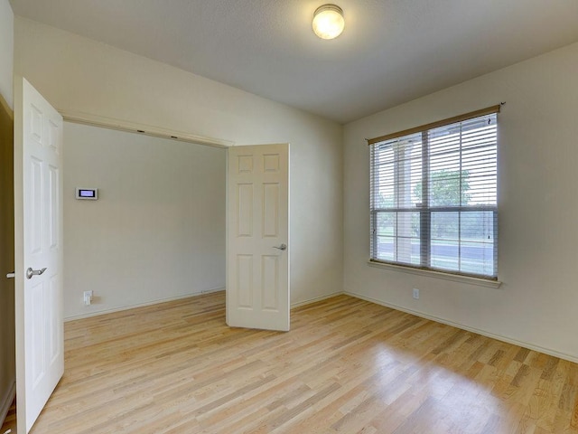 11509 Timber Heights Dr, Austin, TX 78754 - spare room featuring light wood finished floors and lofted ceiling