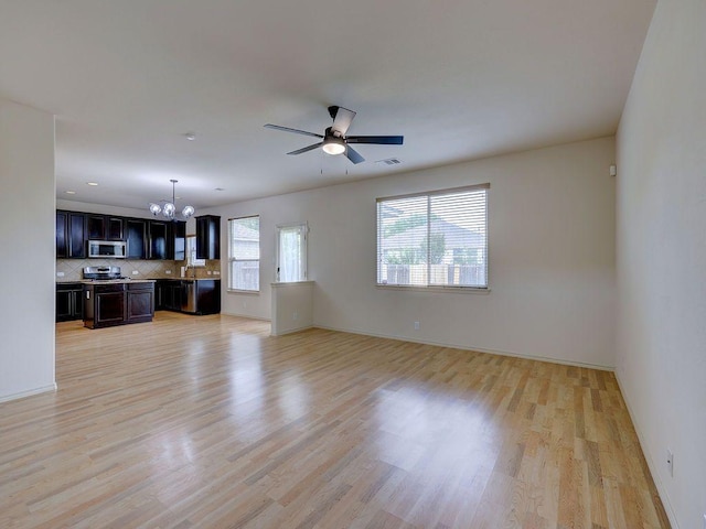 11509 Timber Heights Dr, Austin, TX 78754 - unfurnished living room with a chandelier, light wood-type flooring, and ceiling fan