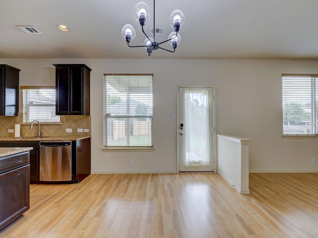 11509 Timber Heights Dr, Austin, TX 78754 - kitchen featuring stainless steel dishwasher, light wood finished floors, a chandelier, dark brown cabinetry, and decorative backsplash