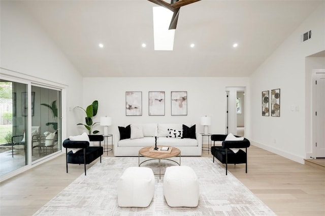 12044 Lincolnshire Dr, Austin, TX 78758 - living room with high vaulted ceiling, light wood-style flooring, recessed lighting, and a skylight
