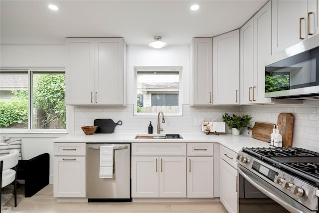 12044 Lincolnshire Dr, Austin, TX 78758 - kitchen featuring appliances with stainless steel finishes, backsplash, light countertops, and recessed lighting