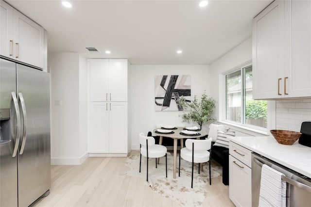 12044 Lincolnshire Dr, Austin, TX 78758 - kitchen featuring stainless steel appliances, recessed lighting, light wood finished floors, light countertops, and backsplash