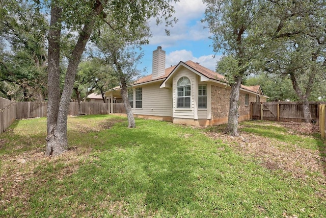 1500 Amelia Dr, Cedar Park, TX 78613 - rear view of house with a chimney and a fenced backyard