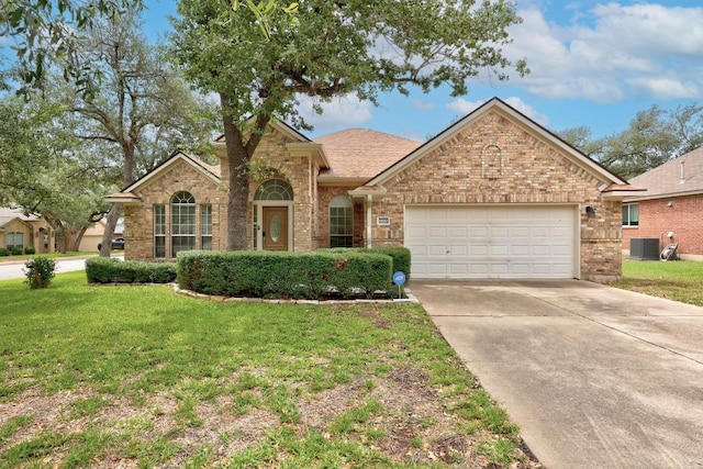 1500 Amelia Dr, Cedar Park, TX 78613 - traditional-style house with driveway, a garage, a front yard, and brick siding