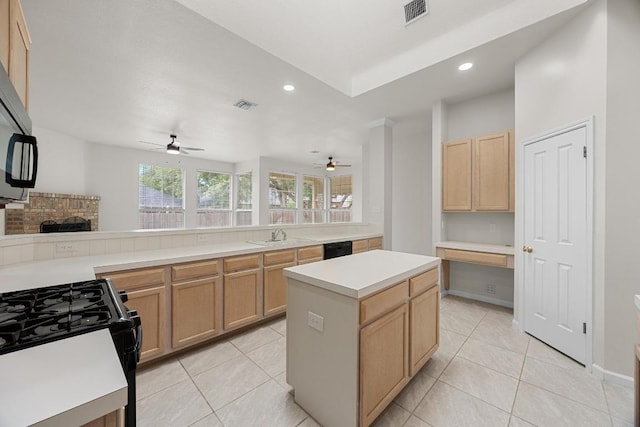 1500 Amelia Dr, Cedar Park, TX 78613 - kitchen featuring ceiling fan, light brown cabinets, light countertops, gas stove, and a brick fireplace