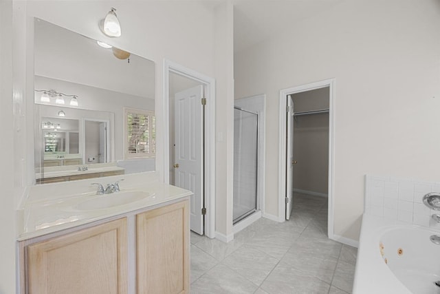 1500 Amelia Dr, Cedar Park, TX 78613 - bathroom featuring a shower stall, a tub with jets, vanity, a walk in closet, and tile patterned flooring