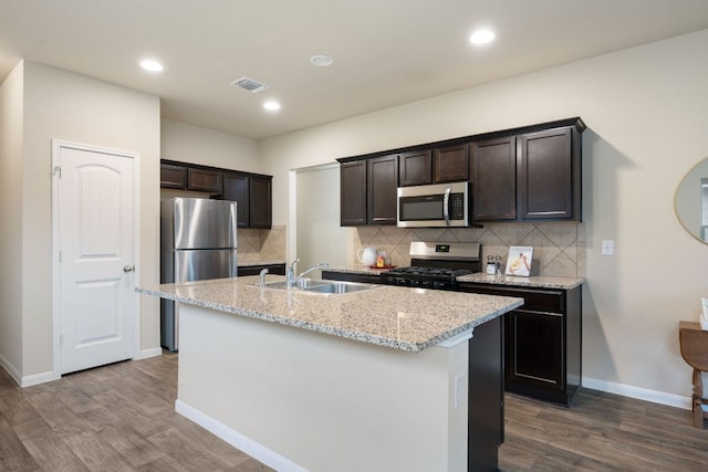 3305 Tilmon Ln, Austin, TX 78725 - kitchen featuring appliances with stainless steel finishes, dark wood-type flooring, backsplash, and recessed lighting