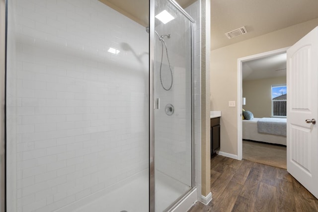 3305 Tilmon Ln, Austin, TX 78725 - ensuite bathroom with a stall shower, wood finished floors, and vanity