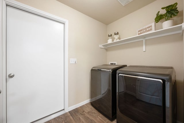 3305 Tilmon Ln, Austin, TX 78725 - laundry area with washer and clothes dryer and wood finished floors