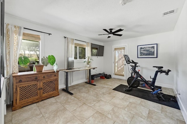 15507 Enid Dr, Austin, TX 78734 - exercise room with healthy amount of natural light, a ceiling fan, and a textured ceiling