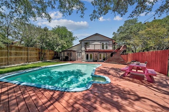 15507 NE Enid Dr, Austin, TX 78734 - view of pool featuring french doors, a deck, a fenced backyard, and stairs