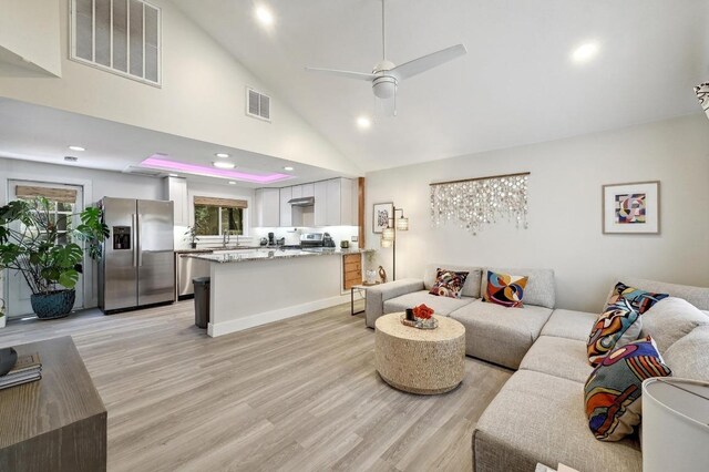 15507 NE Enid Dr, Austin, TX 78734 - living room featuring a ceiling fan, light wood finished floors, recessed lighting, and high vaulted ceiling